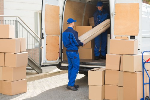 Moving van and packed boxes for a home move in Putney