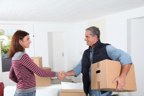 Unpacking boxes and arranging belongings in a new Putney property